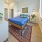 Luxury Studio Apartments West Sacramento, CA | The Bernice | Bedroom with Luxury Vinyl Tile Flooring, Area Rug, Large Bed, Nightstands, Wall-Mounted Lamps, and Spacious Closet.